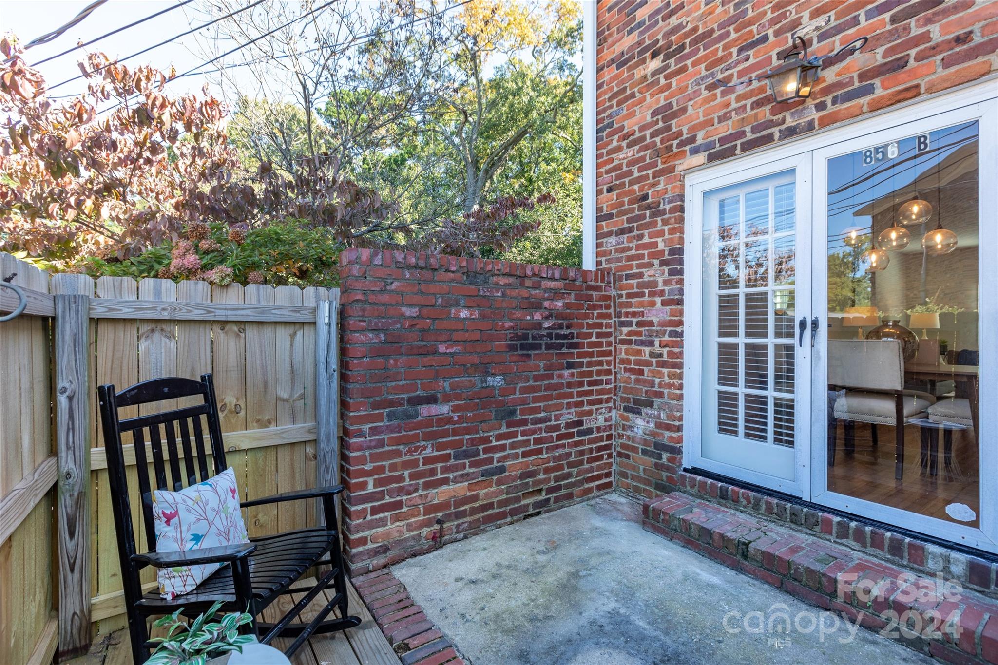 856 McAlway Road, Unit B Charlotte, NC 28211 - Photo 21 of 25 a view of a deck with table and chairs and wooden fence