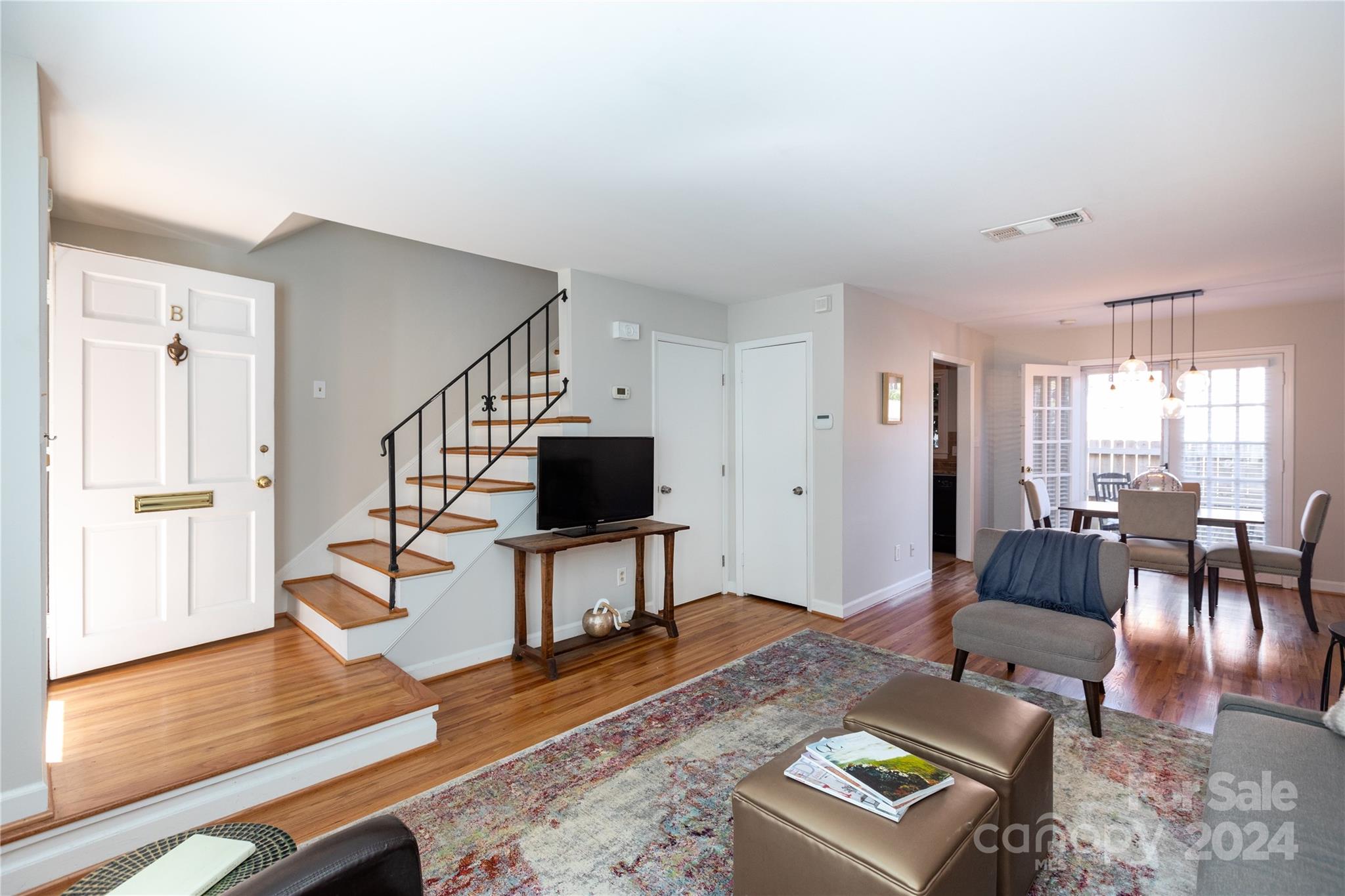 856 McAlway Road, Unit B Charlotte, NC 28211 - Photo 3 of 25 a living room with furniture a dining table and a wooden floor