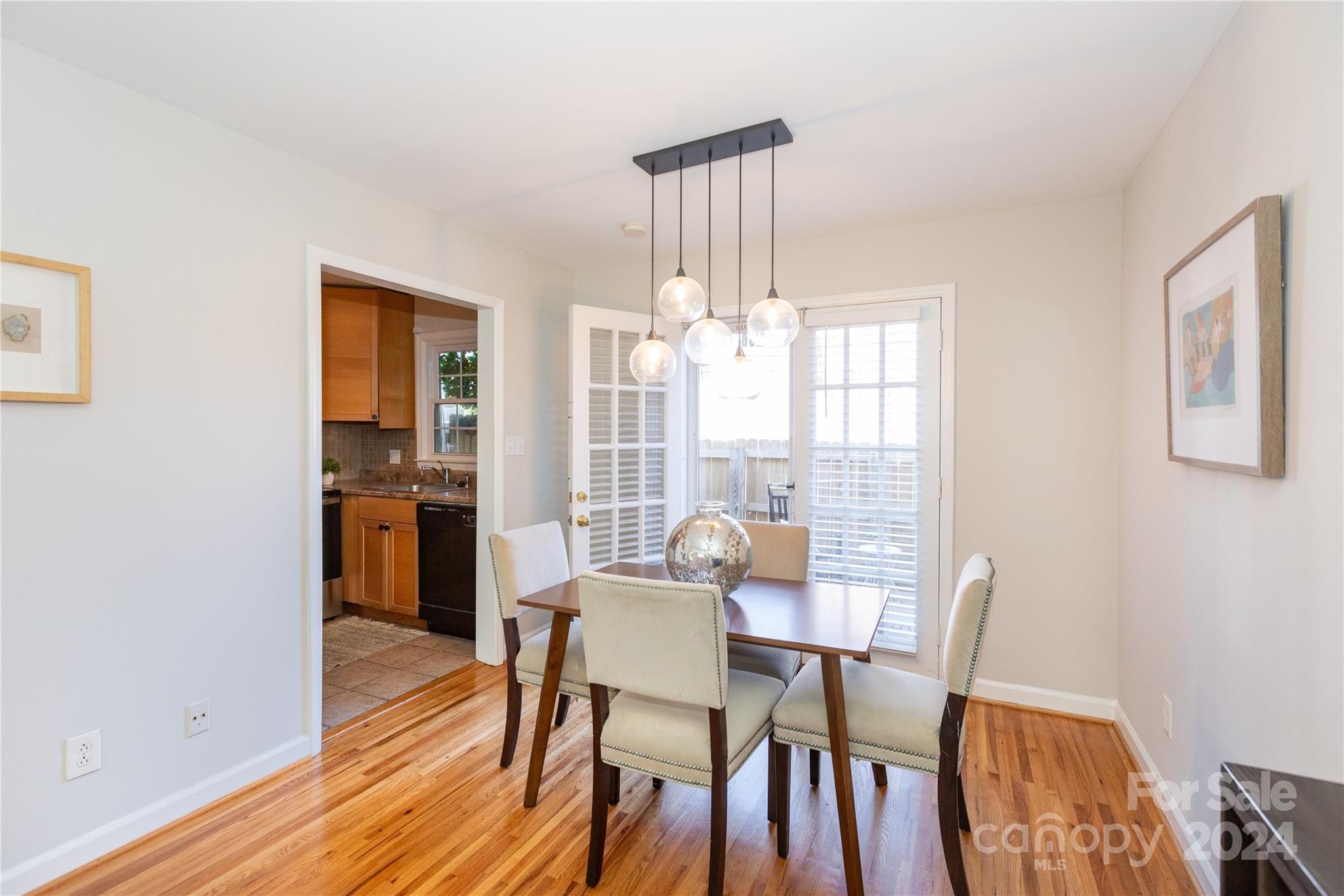 856 McAlway Road, Unit B Charlotte, NC 28211 - Photo 5 of 25 a view of a dining room with furniture window and wooden floor