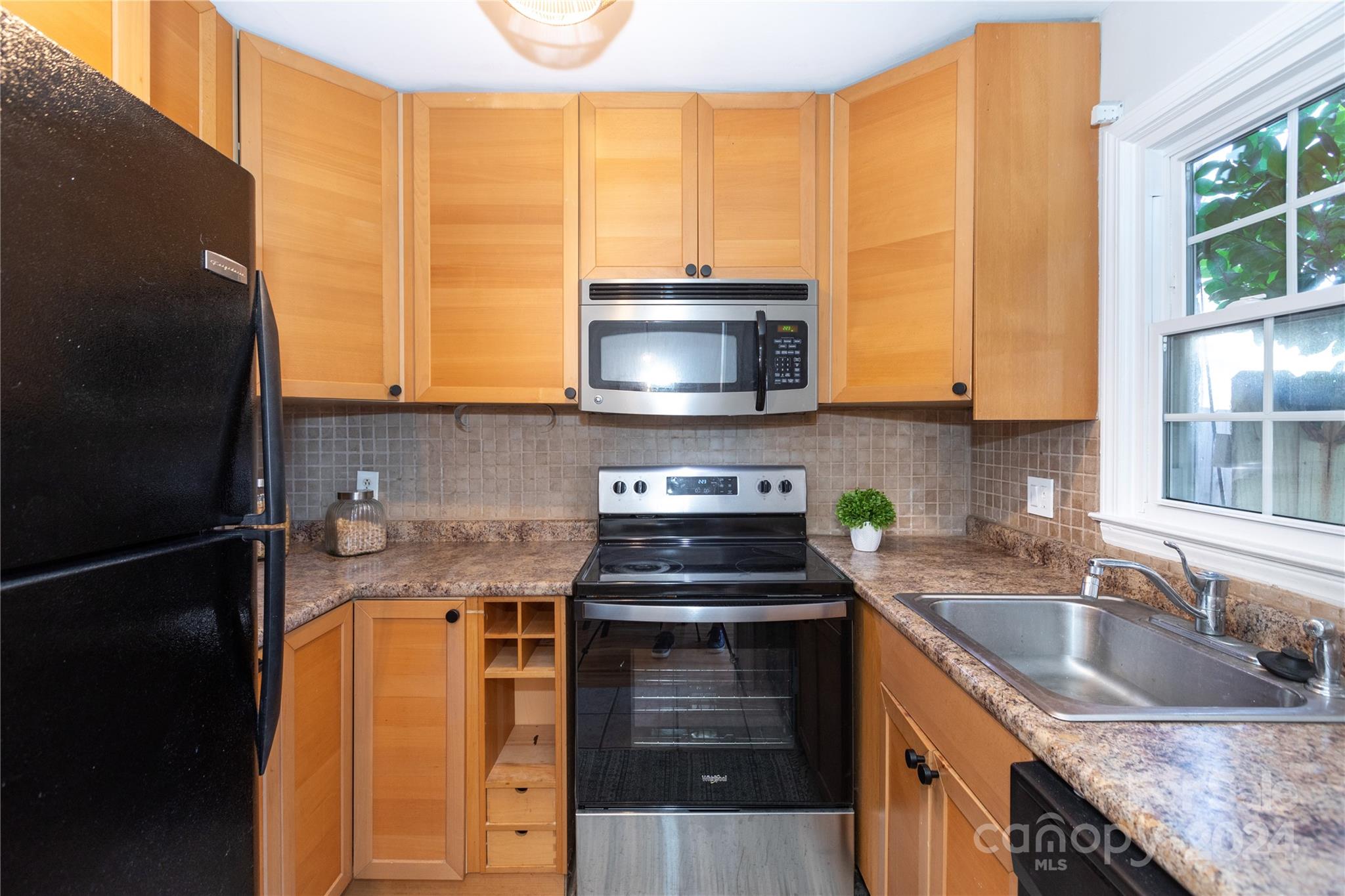 856 McAlway Road, Unit B Charlotte, NC 28211 - Photo 7 of 25 a kitchen with stainless steel appliances granite countertop a stove a sink and a microwave
