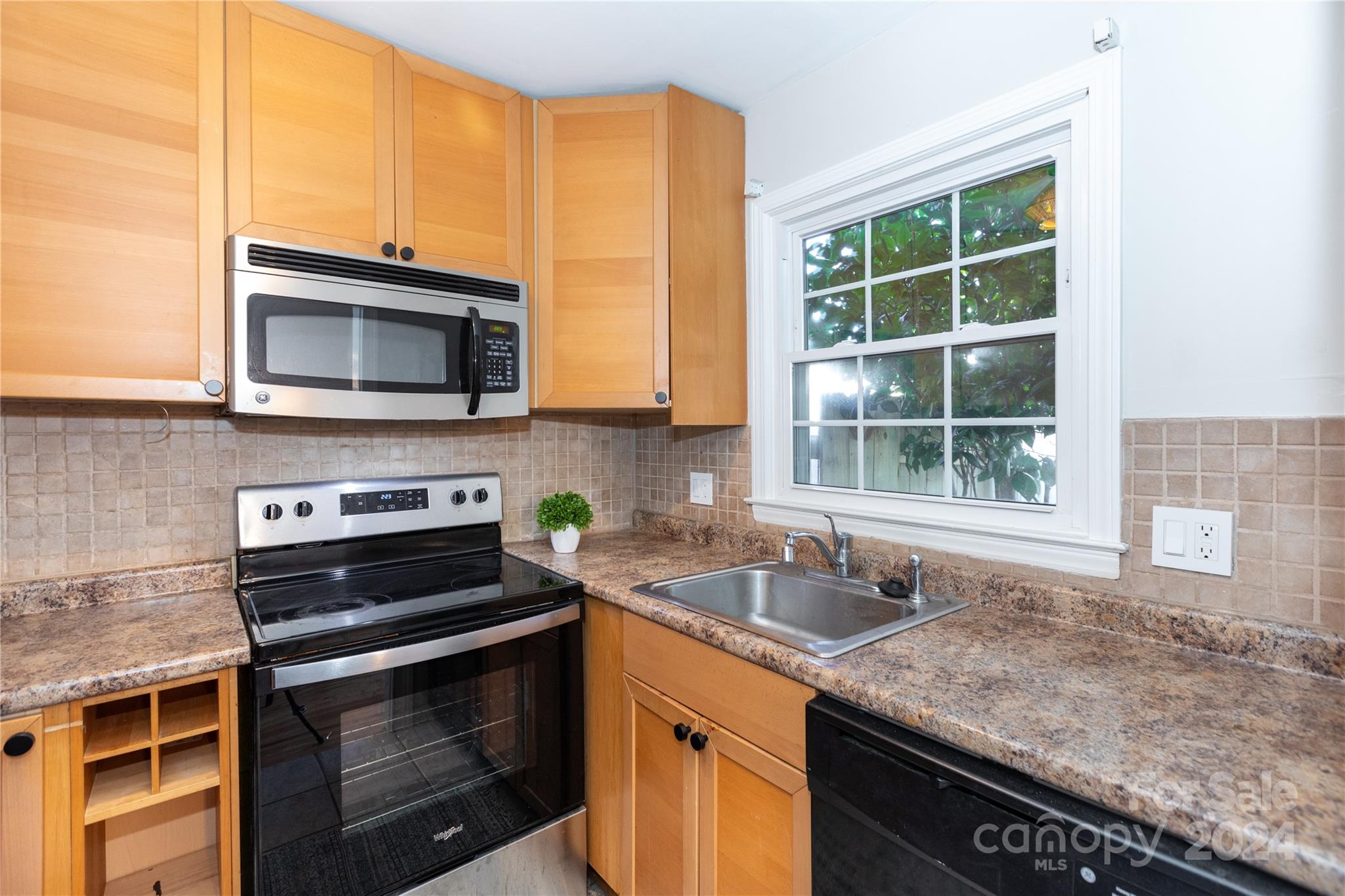 856 McAlway Road, Unit B Charlotte, NC 28211 - Photo 8 of 25 a kitchen with granite countertop a sink stove and microwave
