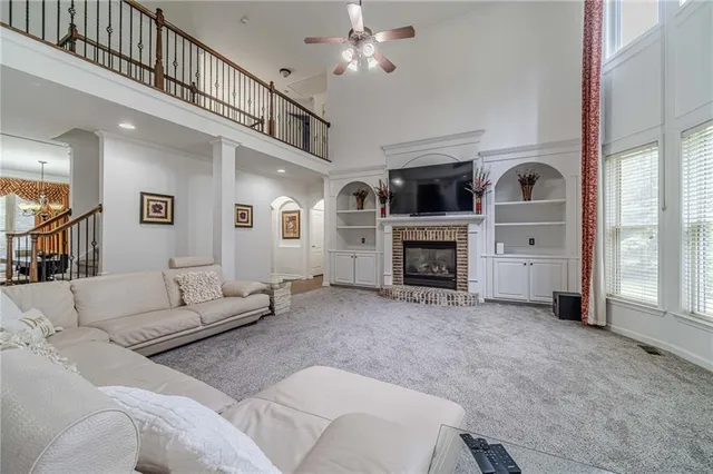 a kitchen with stainless steel appliances granite countertop a refrigerator a stove and a sink