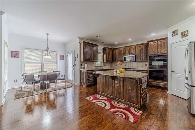 a bedroom with a bed and a flat tv screen on the dresser