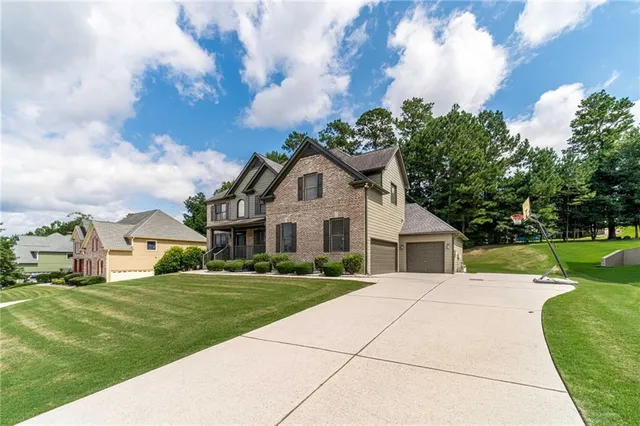 a front view of house with yard and green space