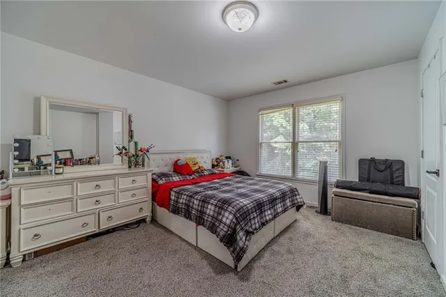 a en suite bathroom with a double vanity sink and a mirror