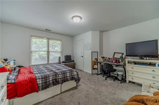 a bedroom with bed and window
