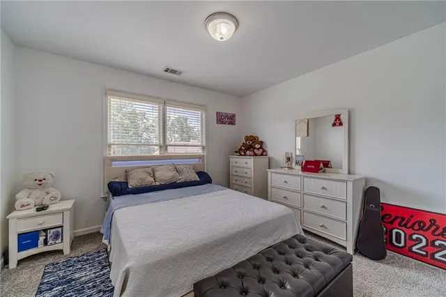 a view of walk in closet with clothes