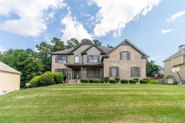 a front view of a house with a yard