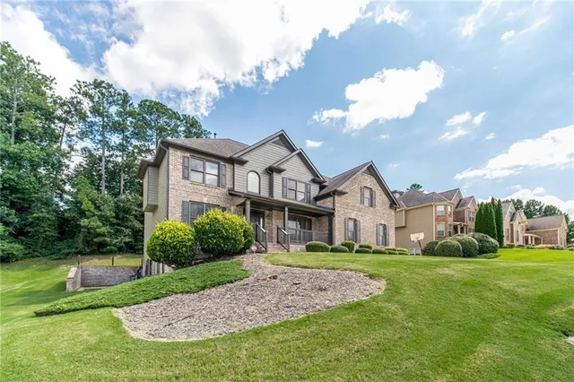 a front view of a house with a garden