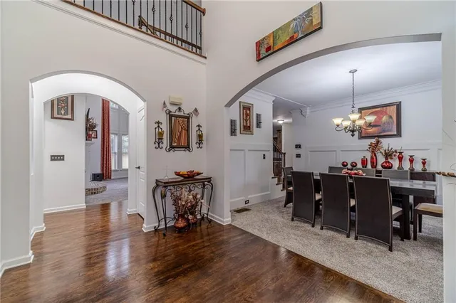 a view of a dining room with furniture and a chandelier