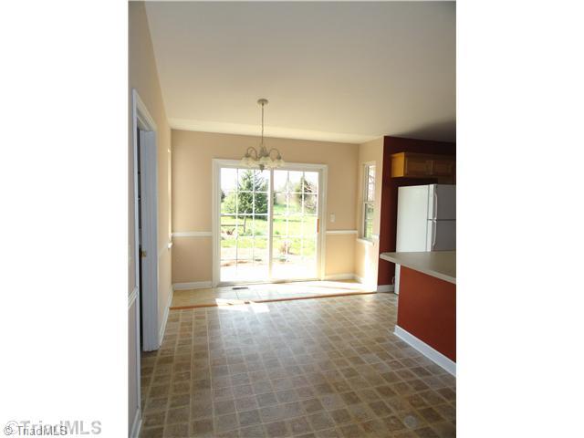 169 Greenfield Road Mocksville, NC 27028 - Photo 4 of 16 Dining Room. Dining Room: Chandelier and sliding glass door to patio.