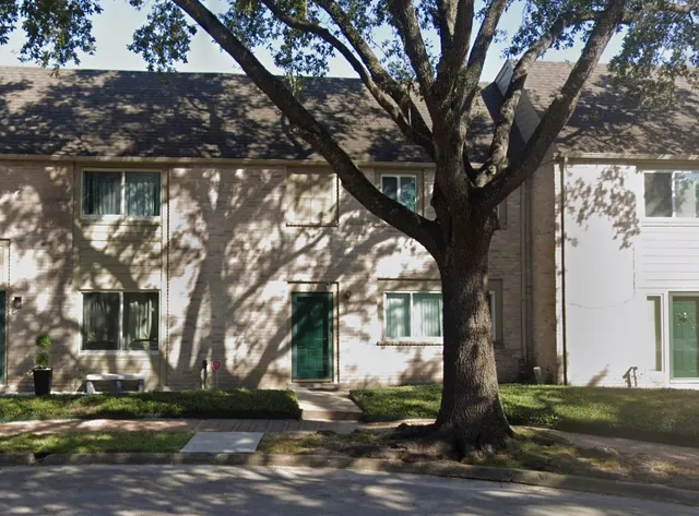 a tree in the middle of a yard