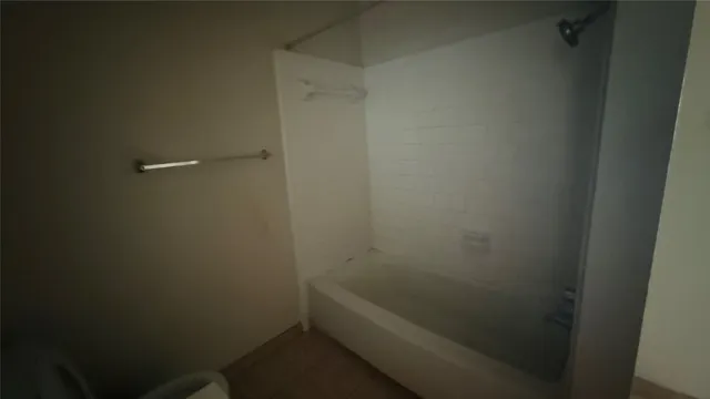 a bathroom with a granite countertop toilet and sink