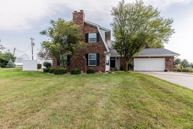 a front view of house with a garden