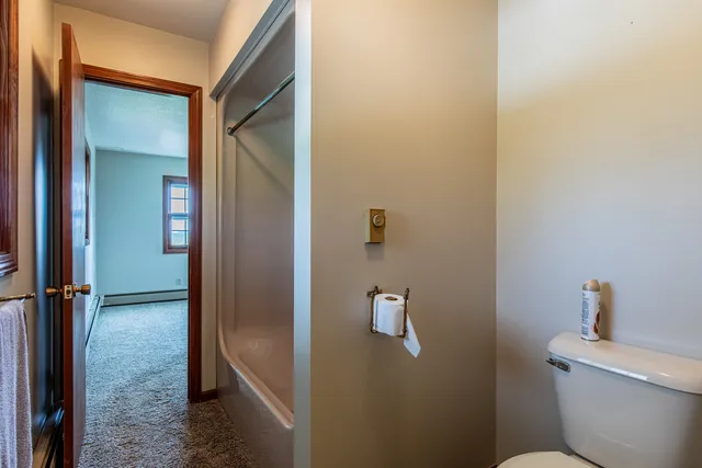 a bathroom with a granite countertop toilet and a sink