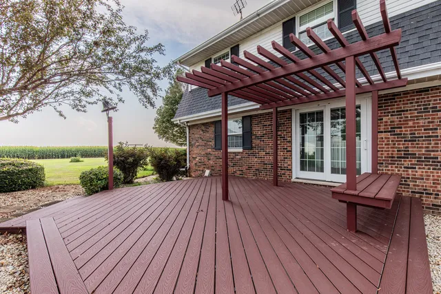 a view of a patio with table and chairs and wooden floor