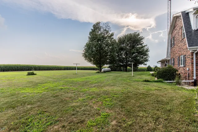 a view of yard with swimming pool and green space