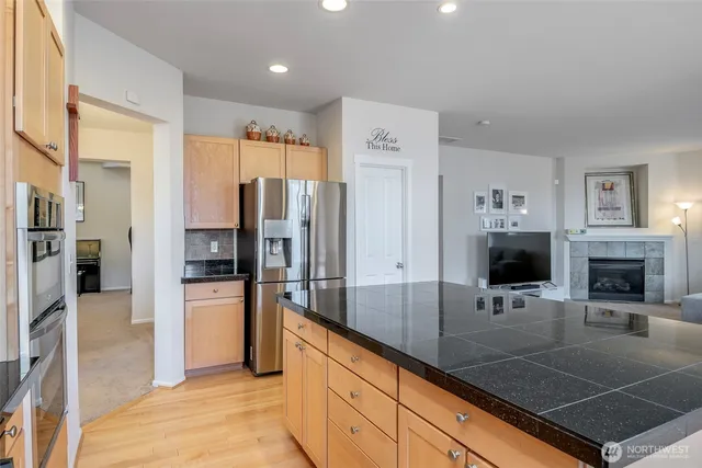 a kitchen with stainless steel appliances a refrigerator sink and stove