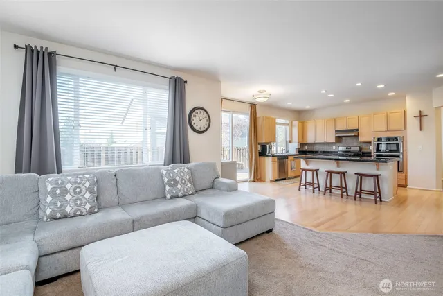 a living room with furniture and kitchen view