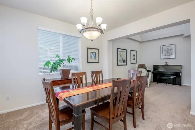 a view of a dining room with furniture and chandelier