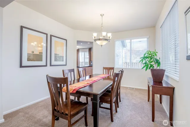 a view of a dining room with furniture and window