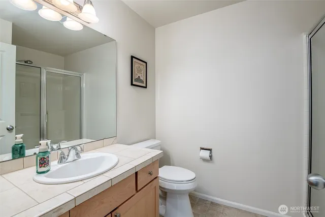 a bathroom with a sink a toilet and mirror