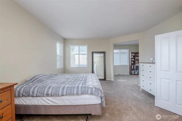 a bedroom with a bed and cabinet