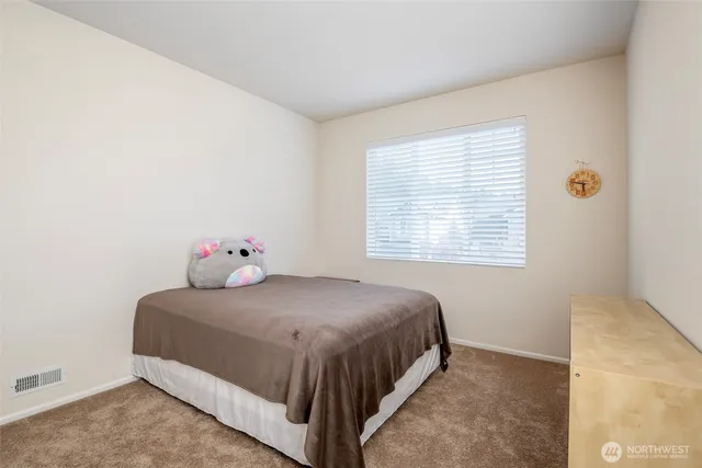 a bedroom with a bed and window