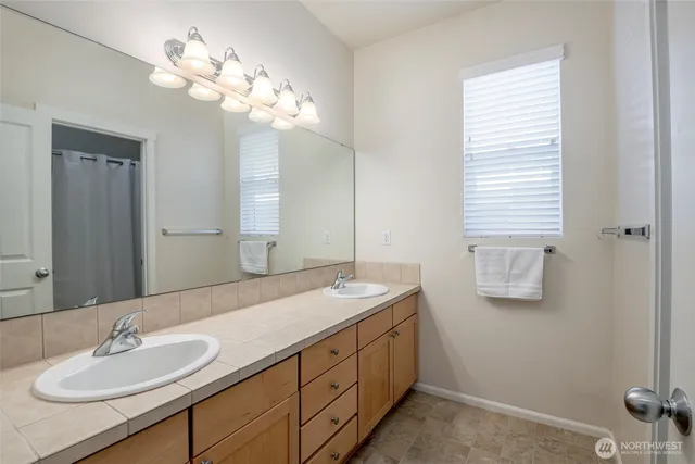 a bathroom with a sink a light fixture and a mirror