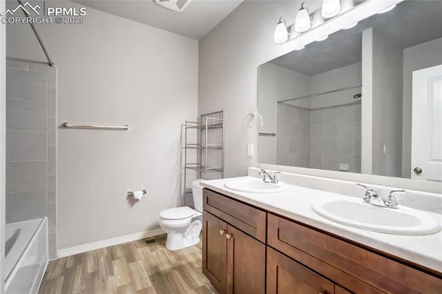a bathroom with a sink a toilet a light fixture and a mirror