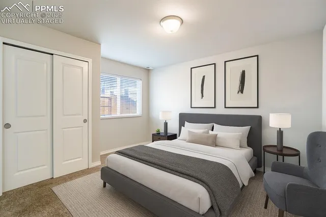 a bedroom with a large bed and a window