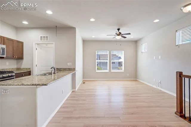 a large kitchen with granite countertop a large counter top space appliances and cabinets