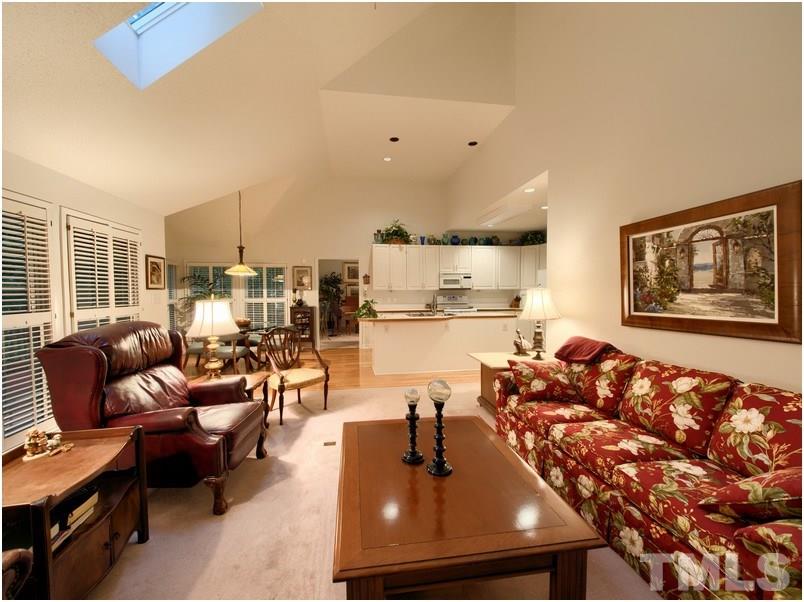 8501 Bluebill Court Raleigh, NC 27615 - Photo 11 of 25 Family room has lots of light from bank of windows with plantation shutters and skylights.