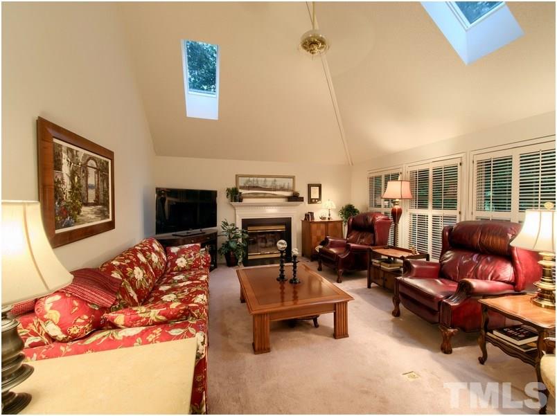 8501 Bluebill Court Raleigh, NC 27615 - Photo 12 of 25 Cozy family room has fireplace with gas logs and ceiling fan.