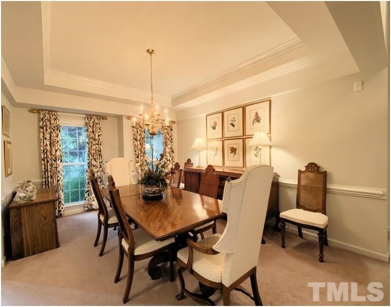 Beautiful dining room with  trey ceiling.