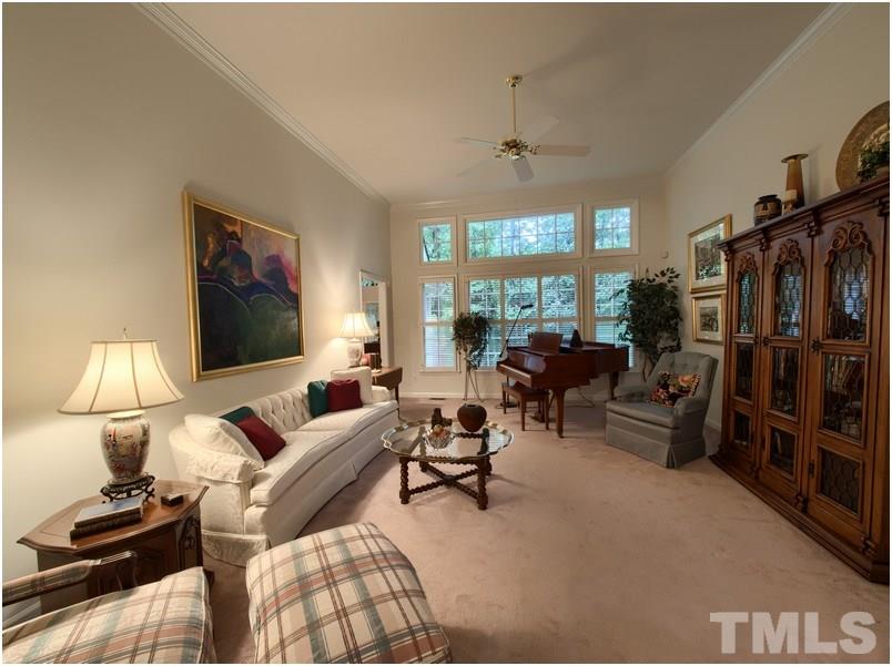 Living room has wall of windows that over look beautiful back yard.