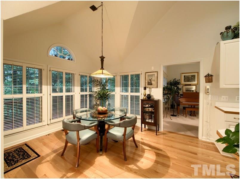 8501 Bluebill Court Raleigh, NC 27615 - Photo 8 of 25 Charming breakfast area tucked in nook beside kitchen and family room provides lots of natural light and view of back yard.