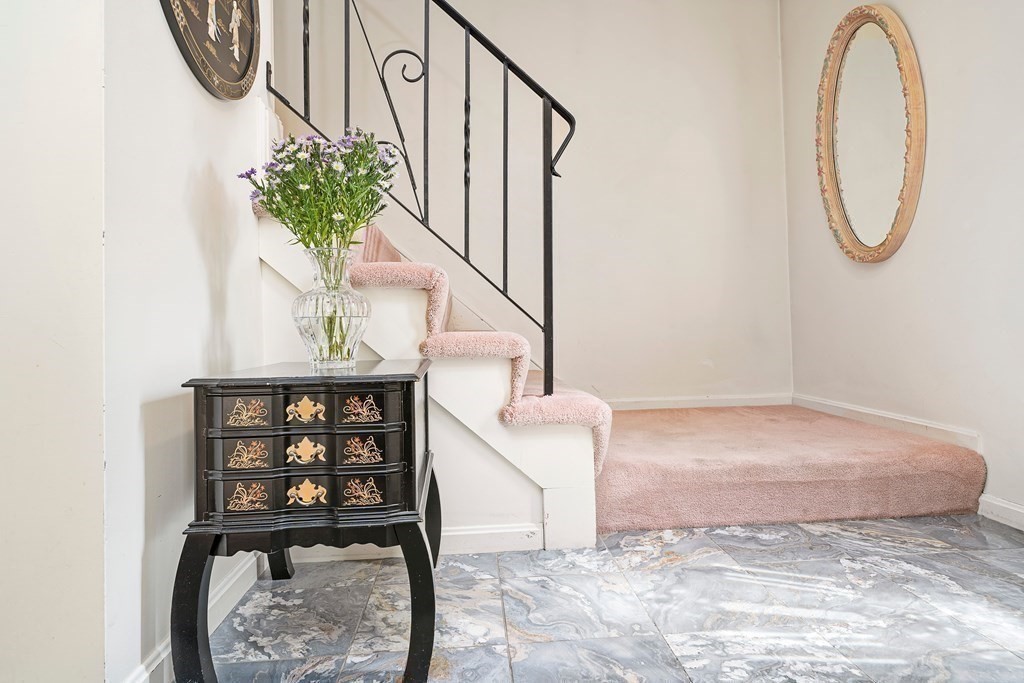 160 Winchester Road Arlington, MA 02474 - Photo 17 of 33 a view of a hallway with wooden floor and a potted plant