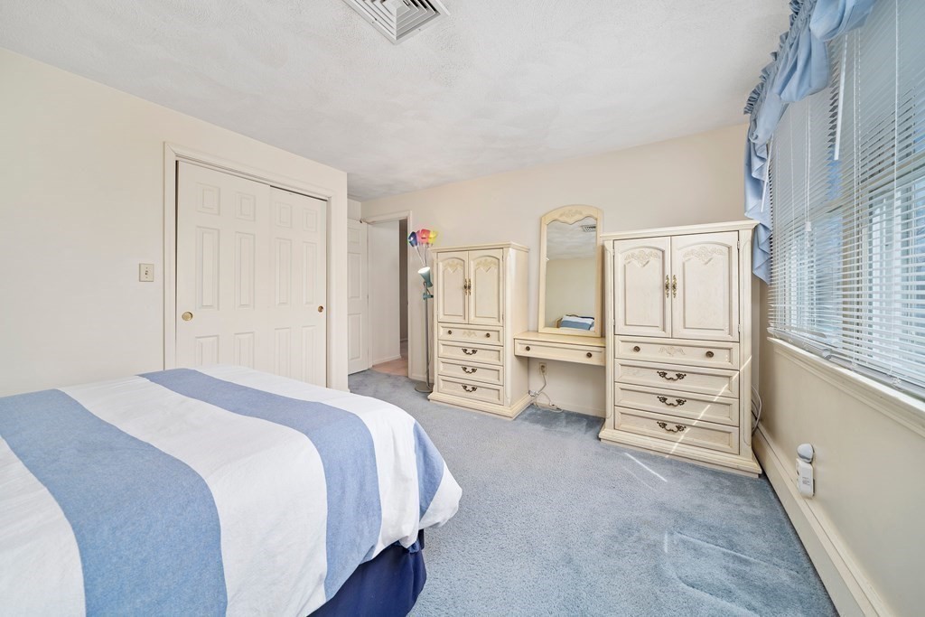 160 Winchester Road Arlington, MA 02474 - Photo 20 of 33 a spacious bedroom with a bed and cabinets