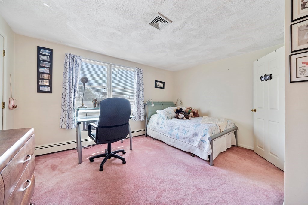 160 Winchester Road Arlington, MA 02474 - Photo 22 of 33 a bedroom with a bed and a chair
