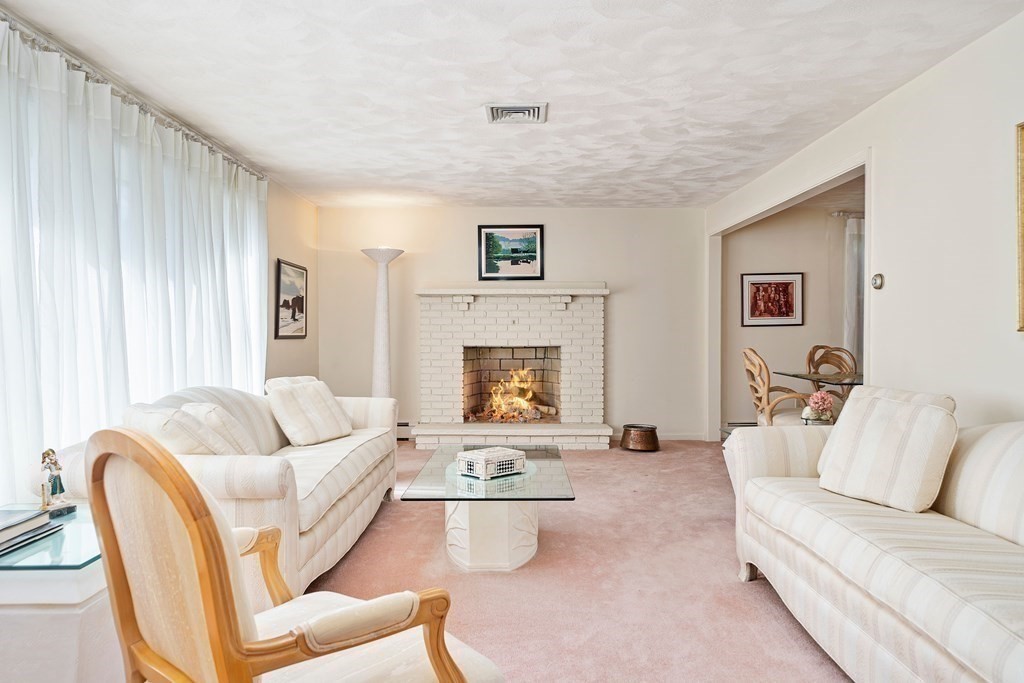 160 Winchester Road Arlington, MA 02474 - Photo 6 of 33 a living room with furniture and a fireplace