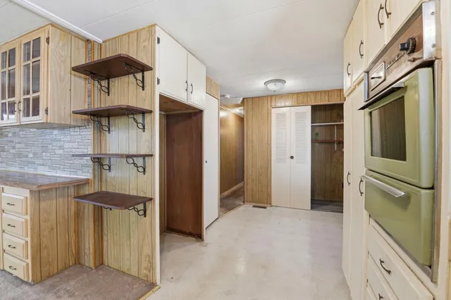 a bathroom with a mirror and a walk in closet