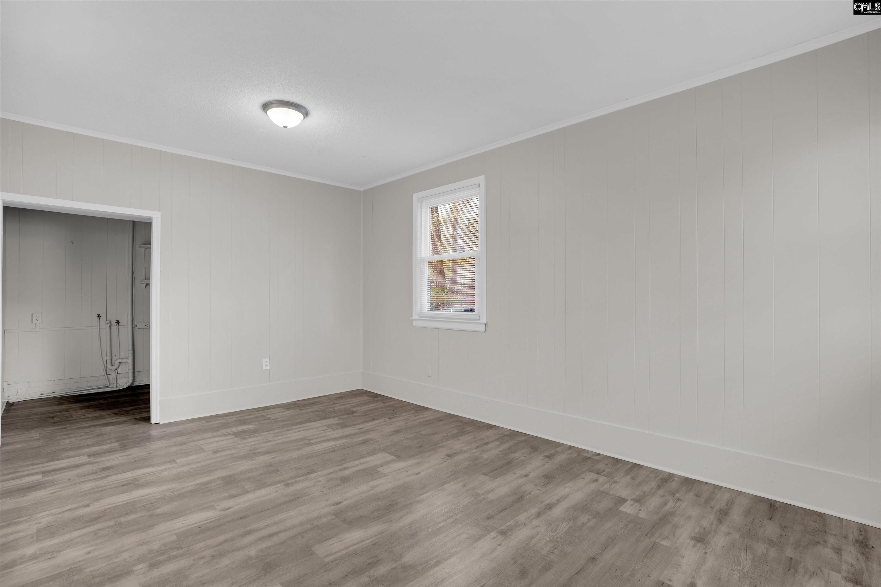 2620 Pleasant Ridge Drive Columbia, SC 29209 - Photo 20 of 37 a view of an empty room with wooden floor and a window