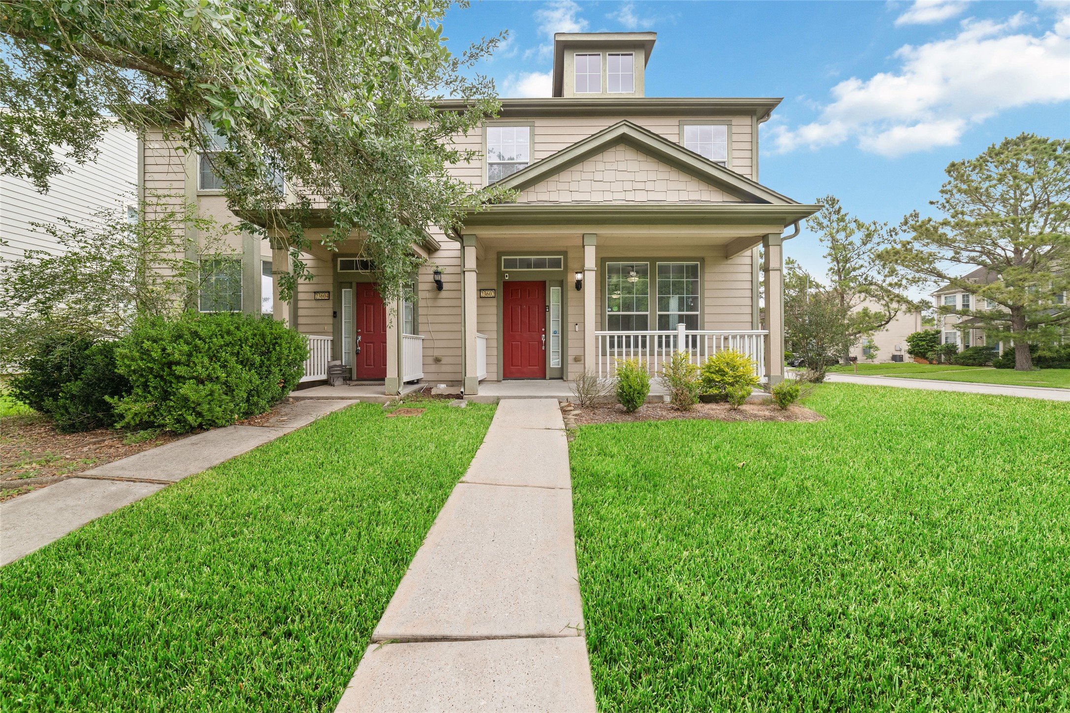 23602 Youpon Lake Lane Spring, TX 77373 - Photo 1 of 21 Charming front exterior with inviting covered porches, manicured landscaping, and mature trees that create a warm welcome home feel.