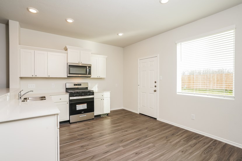3071 Wild Indigo Trail Brookshire, TX 77423 - Photo 4 of 17 a kitchen with stove cabinets and wooden floor