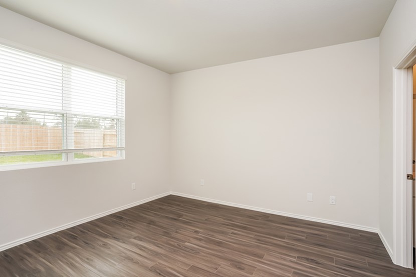3071 Wild Indigo Trail Brookshire, TX 77423 - Photo 9 of 17 an empty room with wooden floor and windows