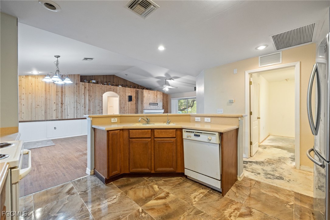 2406 East 23rd Street Alva, FL 33920 - Photo 14 of 33 a kitchen with stainless steel appliances granite countertop a sink a stove a refrigerator and cabinets