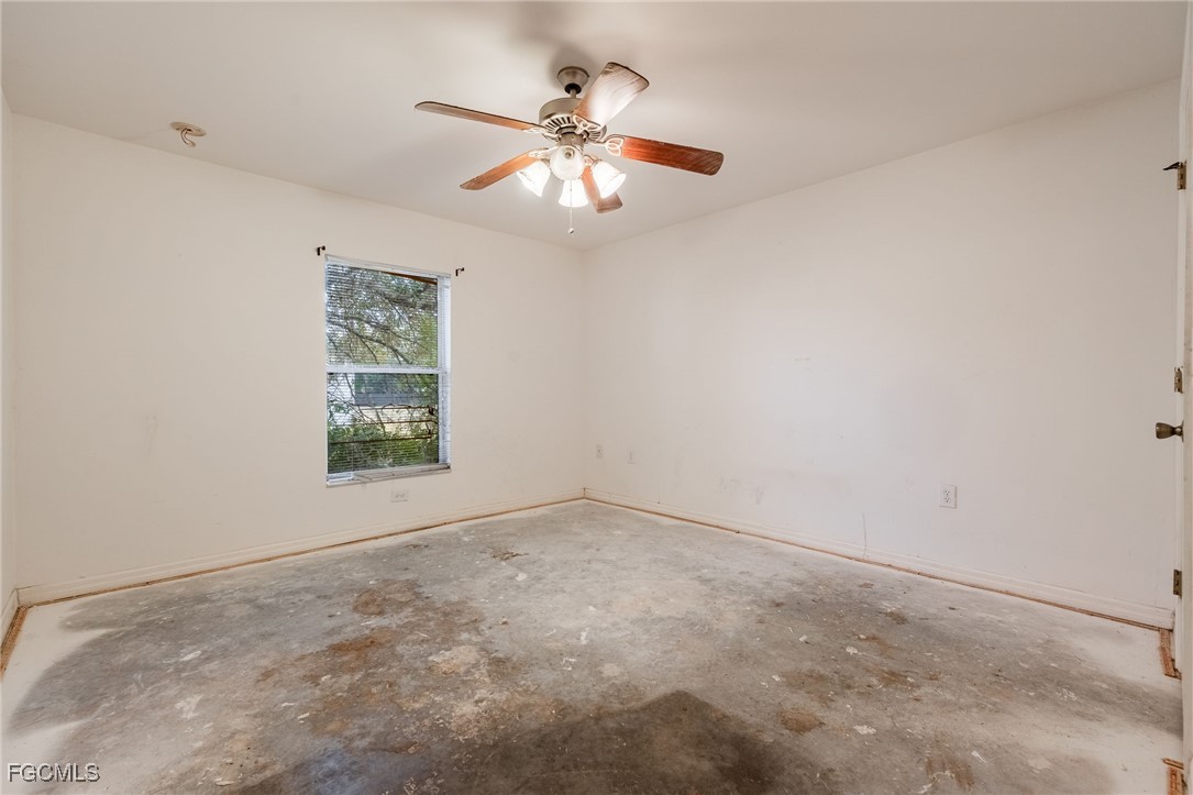 2406 East 23rd Street Alva, FL 33920 - Photo 16 of 33 an empty room with windows and fan