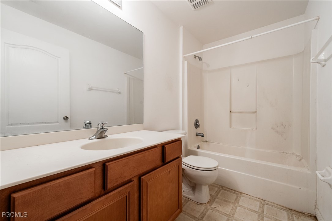 2406 East 23rd Street Alva, FL 33920 - Photo 21 of 33 a bathroom with a sink a toilet and shower