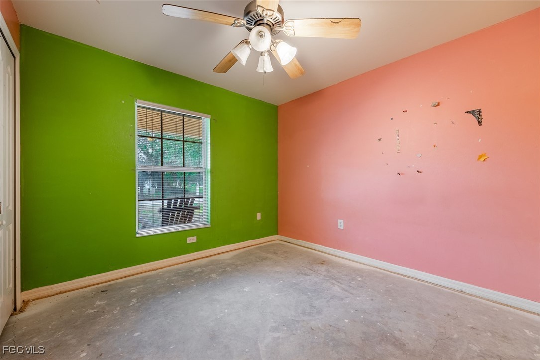 2406 East 23rd Street Alva, FL 33920 - Photo 22 of 33 an empty room with a window and a ceiling fan
